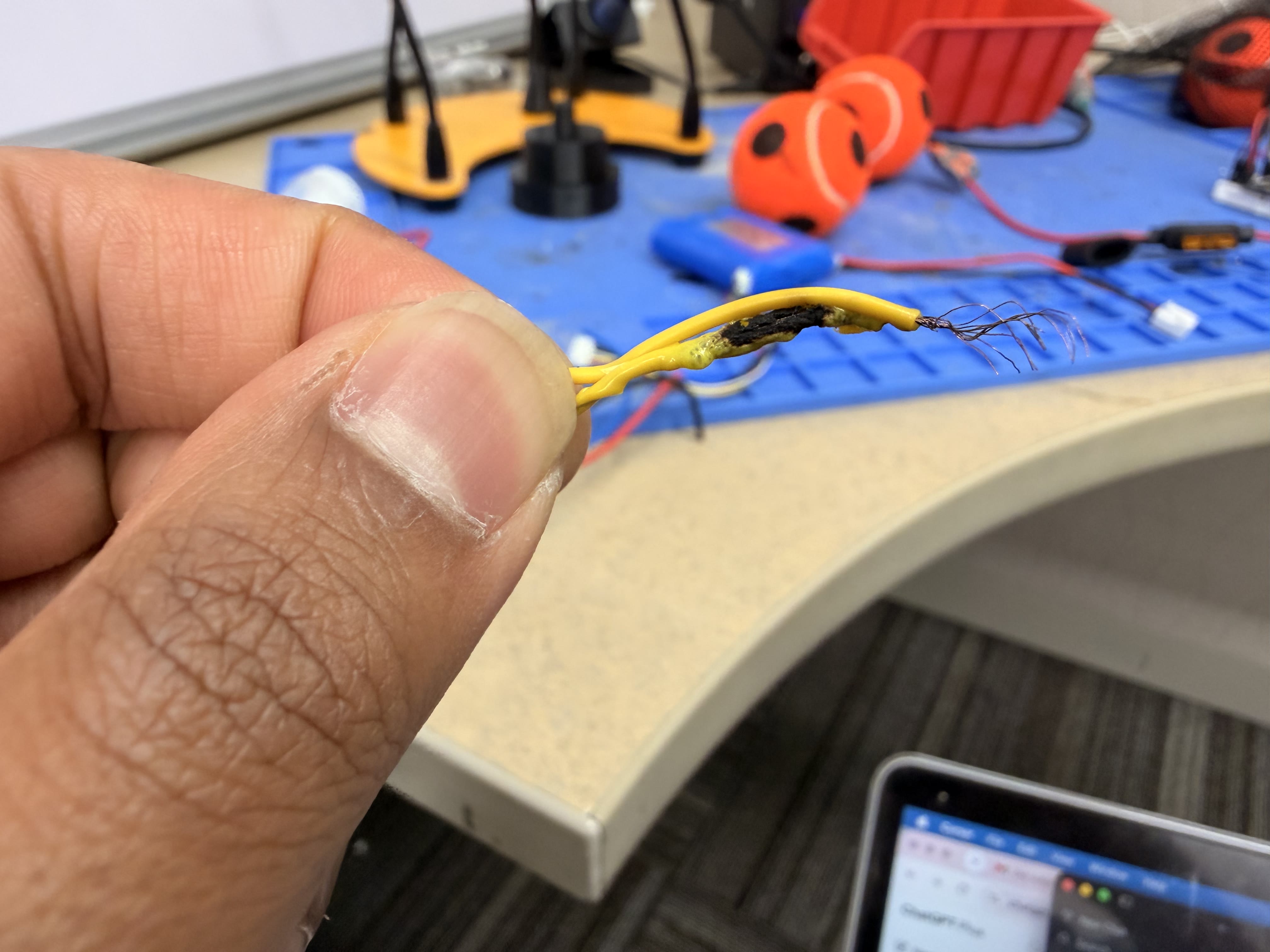 Melted and charred yellow wire after overspeed event